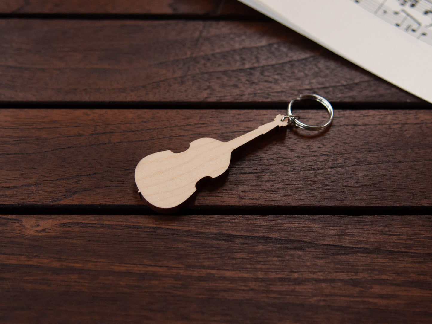 A double bass shaped keychain made from maple wood